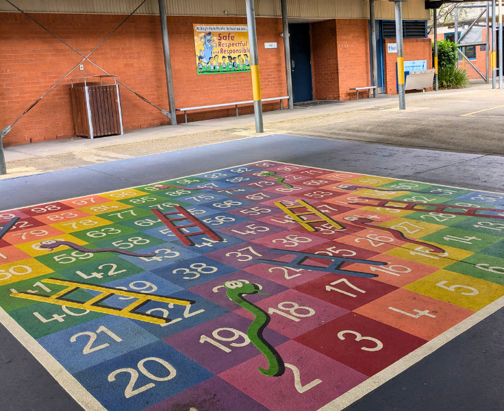 Large Snakes and Ladders game painted on the playground
