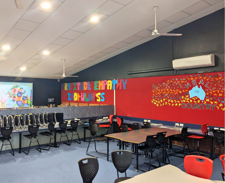 The tables and chairs in the computer section of our school library