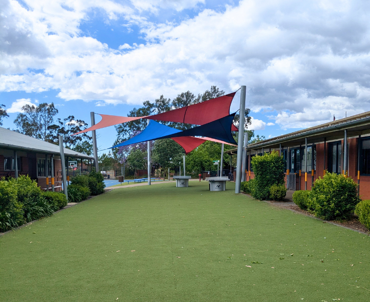 Covered grassed area with tables to play Ping Pong