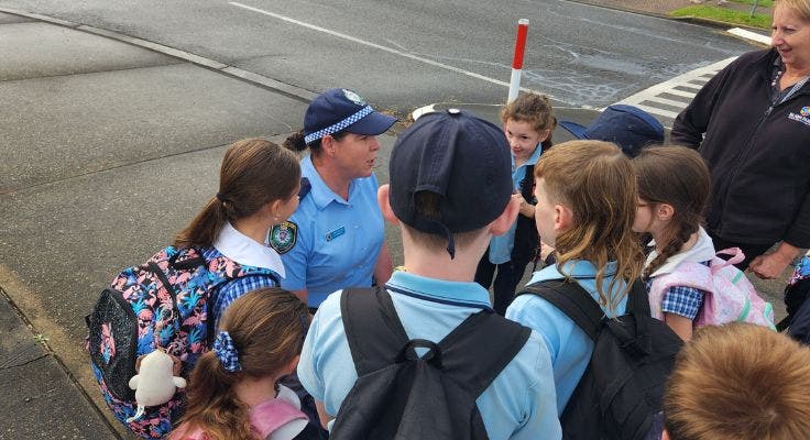 A police woman talking to a group of students on Walk Safely to School day